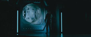 Movie still from “Star Trek Into Darkness” (2013), directed by J.J. Abrams – A man standing in front of a wall with lights on it; Wide shot, Low angle