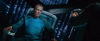 Movie still from “Star Trek Into Darkness” (2013), directed by J.J. Abrams – A man sitting on a chair in a room; Medium shot, Overhead angle