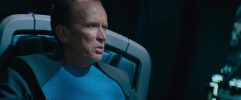 Movie still from “Star Trek Into Darkness” (2013), directed by J.J. Abrams – An older man sitting in a chair looking off into the distance; Close Up shot, Over the shoulder angle