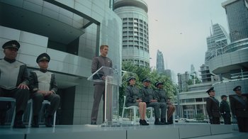 Movie still from “Star Trek Into Darkness” (2013), directed by J.J. Abrams – A group of people sitting on chairs in front of a building; Wide shot, Low angle
