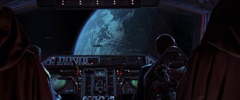 Movie still from “Star Wars: Episode I - The Phantom Menace” (1999), directed by George Lucas – A man in the cockpit of a space ship looking out at the earth; Extreme Wide shot, High angle