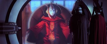 Movie still from “Star Wars: Episode I - The Phantom Menace” (1999), directed by George Lucas – A woman dressed in a red outfit with horns; Medium shot, Over the shoulder angle
