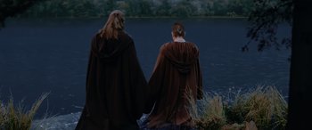 Movie still from “Star Wars: Episode I - The Phantom Menace” (1999), directed by George Lucas – A couple of people standing next to a body of water; Wide shot, Over the shoulder angle