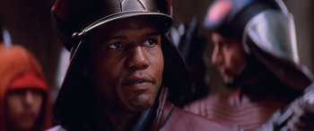 Movie still from “Star Wars: Episode I - The Phantom Menace” (1999), directed by George Lucas – A person wearing a helmet; Close Up shot, Over the shoulder angle