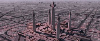 Movie still from “Star Wars: Episode I - The Phantom Menace” (1999), directed by George Lucas – An aerial view of a city with a bunch of tall towers; Extreme Wide shot, High angle