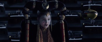 Movie still from “Star Wars: Episode I - The Phantom Menace” (1999), directed by George Lucas – A young girl wearing a costume and a headpiece; Close Up shot, Over the shoulder angle
