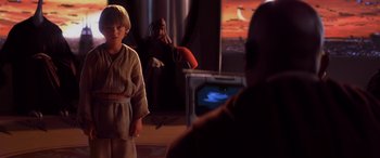 Movie still from “Star Wars: Episode I - The Phantom Menace” (1999), directed by George Lucas – A young boy in a star wars costume watching a television; Medium shot, Over the shoulder angle