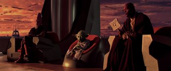 Movie still from “Star Wars: Episode I - The Phantom Menace” (1999), directed by George Lucas – A star wars character sitting in a chair; Wide shot, High angle