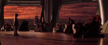 Movie still from “Star Wars: Episode I - The Phantom Menace” (1999), directed by George Lucas – A group of people sitting in a room with a city in the background; Extreme Wide shot, High angle