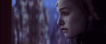 Movie still from “Star Wars: Episode I - The Phantom Menace” (1999), directed by George Lucas – A person with a face paint on; Close Up shot, Over the shoulder angle