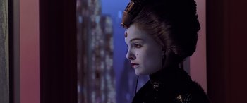 Movie still from “Star Wars: Episode I - The Phantom Menace” (1999), directed by George Lucas – A woman in a black outfit with a black and red dot on it's forehead; Close Up shot, Over the shoulder angle