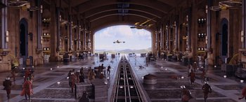 Movie still from “Star Wars: Episode I - The Phantom Menace” (1999), directed by George Lucas – An airplane is flying in the sky over a train station; Extreme Wide shot, High angle