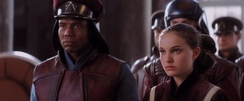 Movie still from “Star Wars: Episode I - The Phantom Menace” (1999), directed by George Lucas – A group of people standing next to each other; Close Up shot, Over the shoulder angle