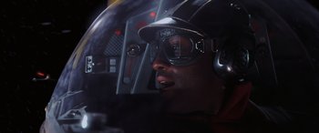Movie still from “Star Wars: Episode I - The Phantom Menace” (1999), directed by George Lucas – A man wearing a helmet and goggles in a cockpit of an airplane; Close Up shot, Low angle