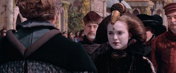 Movie still from “Star Wars: Episode I - The Phantom Menace” (1999), directed by George Lucas – A group of people dressed up in costumes; Close Up shot, Over the shoulder angle