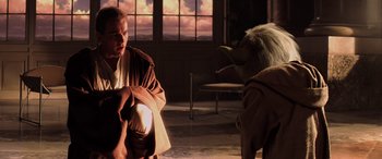 Movie still from “Star Wars: Episode I - The Phantom Menace” (1999), directed by George Lucas – A man and a stuffed animal in a room with a window; Medium shot, Over the shoulder angle