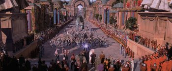 Movie still from “Star Wars: Episode I - The Phantom Menace” (1999), directed by George Lucas – A crowd of people standing in front of an elephant statue; Extreme Wide shot, High angle