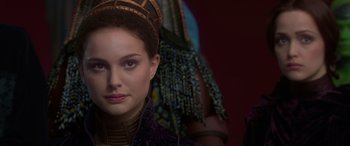 Movie still from “Star Wars: Episode II - Attack of the Clones” (2002), directed by George Lucas – A person wearing a hat; Close Up shot, Over the shoulder angle