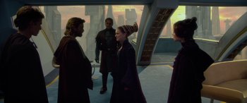 Movie still from “Star Wars: Episode II - Attack of the Clones” (2002), directed by George Lucas – A group of people standing next to each other on top of a building; Medium shot, Over the shoulder angle