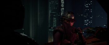 Movie still from “Star Wars: Episode II - Attack of the Clones” (2002), directed by George Lucas – A person wearing a helmet in front of a window; Medium shot, Over the shoulder angle