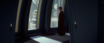 Movie still from “Star Wars: Episode II - Attack of the Clones” (2002), directed by George Lucas – A man standing in front of a large window; Wide shot, High angle