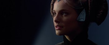 Movie still from “Star Wars: Episode II - Attack of the Clones” (2002), directed by George Lucas – A woman's face in a dark room; Close Up shot, Over the shoulder angle
