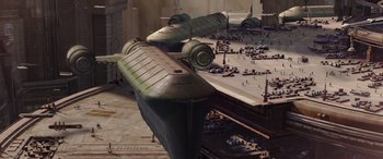 Movie still from “Star Wars: Episode II - Attack of the Clones” (2002), directed by George Lucas – An aerial view of an airport with planes parked on top of it; Extreme Wide shot, High angle