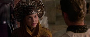 Movie still from “Star Wars: Episode II - Attack of the Clones” (2002), directed by George Lucas – A woman wearing a headdress and a yellow dress; Close Up shot, Over the shoulder angle