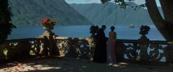 Movie still from “Star Wars: Episode II - Attack of the Clones” (2002), directed by George Lucas – Two people standing on a balcony near a body of water; Wide shot, Over the shoulder angle