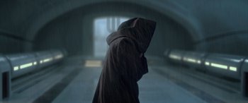 Movie still from “Star Wars: Episode II - Attack of the Clones” (2002), directed by George Lucas – A person in a hooded cloak walking down a hallway; Close Up shot, Low angle