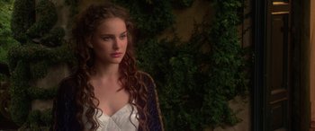 Movie still from “Star Wars: Episode II - Attack of the Clones” (2002), directed by George Lucas – A beautiful young woman with long , red , curly hair wearing a white dress; Close Up shot, Over the shoulder angle
