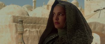 Movie still from “Star Wars: Episode II - Attack of the Clones” (2002), directed by George Lucas – A person wearing a hood and looking to the side; Close Up shot, Low angle