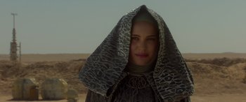 Movie still from “Star Wars: Episode II - Attack of the Clones” (2002), directed by George Lucas – A woman with a head covering on a desert hill; Close Up shot, Low angle