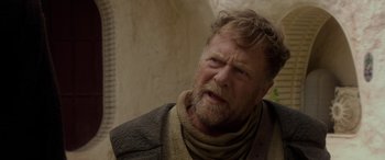 Movie still from “Star Wars: Episode II - Attack of the Clones” (2002), directed by George Lucas – An old man with a beard and a sweater; Close Up shot, Over the shoulder angle