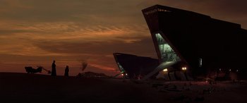 Movie still from “Star Wars: Episode II - Attack of the Clones” (2002), directed by George Lucas – Two buildings are lit up at night in the desert; Extreme Wide shot, Low angle