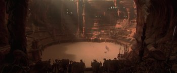Movie still from “Star Wars: Episode II - Attack of the Clones” (2002), directed by George Lucas – A group of people standing in a circle inside a building; Extreme Wide shot, High angle