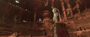 Movie still from “Star Wars: Episode II - Attack of the Clones” (2002), directed by George Lucas – A man standing on top of a rock in a cave; Wide shot, Low angle