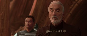 Movie still from “Star Wars: Episode II - Attack of the Clones” (2002), directed by George Lucas – A man with a chain around his neck and another man with a chain around his neck; Close Up shot, Over the shoulder angle