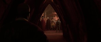 Movie still from “Star Wars: Episode II - Attack of the Clones” (2002), directed by George Lucas – A group of people standing in an archway; Medium shot, Over the shoulder angle