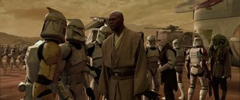 Movie still from “Star Wars: Episode II - Attack of the Clones” (2002), directed by George Lucas – A group of star wars characters standing in a line; Medium shot, Over the shoulder angle
