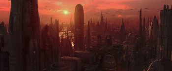An alien city is shown at sunset with a red sky