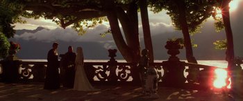 Movie still from “Star Wars: Episode II - Attack of the Clones” (2002), directed by George Lucas – A bride and groom are standing next to a tree; Extreme Wide shot, Over the shoulder angle