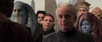 Movie still from “Star Wars: Episode III - Revenge of the Sith” (2005), directed by George Lucas – A man and two women standing next to each other in front of a building; Close Up shot, Over the shoulder angle