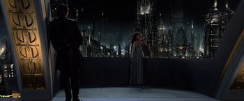 Movie still from “Star Wars: Episode III - Revenge of the Sith” (2005), directed by George Lucas – A woman standing in front of a large city; Wide shot, Over the shoulder angle