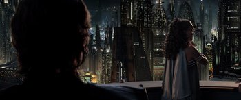 Movie still from “Star Wars: Episode III - Revenge of the Sith” (2005), directed by George Lucas – A view of a city at night from a balcony; Medium shot, Over the shoulder angle