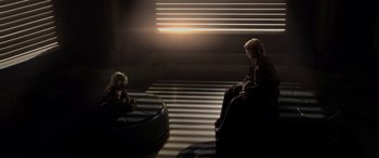 Movie still from “Star Wars: Episode III - Revenge of the Sith” (2005), directed by George Lucas – A woman sitting on a chair next to a small child; Wide shot, Over the shoulder angle
