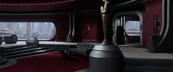Movie still from “Star Wars: Episode III - Revenge of the Sith” (2005), directed by George Lucas – A statue of a person in a room with red walls; Extreme Wide shot, High angle