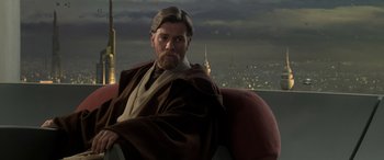Movie still from “Star Wars: Episode III - Revenge of the Sith” (2005), directed by George Lucas – An image of obi wan kenobi sitting in a chair in front of a city skyline; Medium shot, Over the shoulder angle
