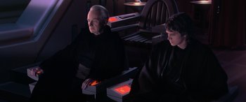 Movie still from “Star Wars: Episode III - Revenge of the Sith” (2005), directed by George Lucas – Two people sitting at a table with boxes of food; Medium shot, High angle