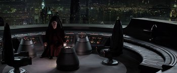 Movie still from “Star Wars: Episode III - Revenge of the Sith” (2005), directed by George Lucas – A man sitting in a chair in front of a large window; Extreme Wide shot, High angle